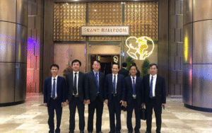 Business delegates posing indoors at a formal event in the Philippines