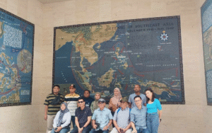 Tour group posing outdoors with a scenic mountain and lake view in the Philippines