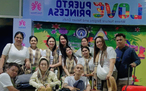 Tour group posing at the Bonifacio High Street welcome sign in Taguig