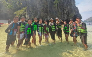 Tour group trekking through a scenic green outdoor trail in the Philippines
